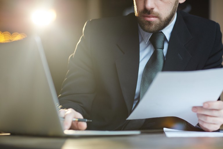 bearded-businessman-working-with-documents-in-office.jpg