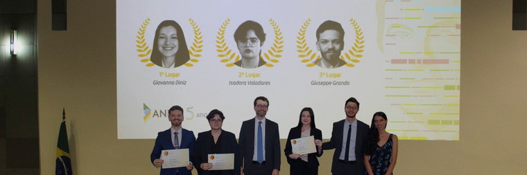 Iagê Miola (ao centro) e Lucas Anjos entregam os prêmios do 3º Concurso Danilo Doneda, juntamente com Dora Doneda (à direita), filha do pesquisador