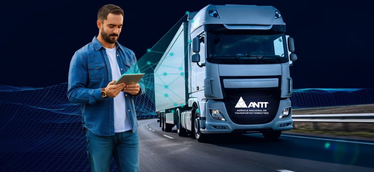 IMAGEM COM UM CAMINHÃO E UM HOMEM OLHANDO UM TABLET