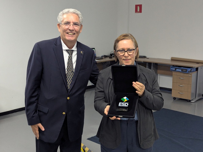 Diretora do Cemaden, Regina Alvalá, recebe placa de homenagem da Escola Superior de Defesa (ESD) das mãos do coordenador-geral acadêmico da ESD, contra-almirante Jefferson de Medeiros.