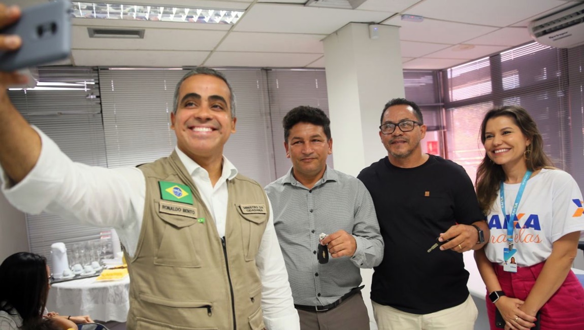 O ministro Ronaldo Bento ao lado de Marcelo e Elias , contemplados pelo Auxílio Taxista em agência da Caixa. Foto: Júlio Dutra/ Min. Cidadania