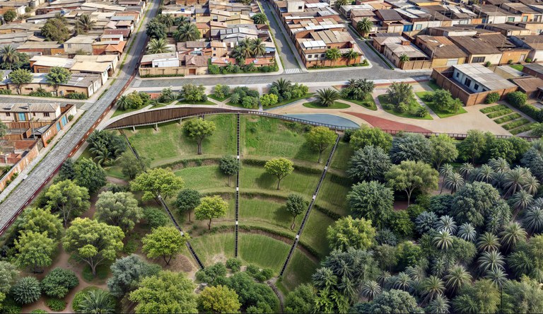 Na foto jardim circular gigante com várias árvores no meio de uma cidade sustentável