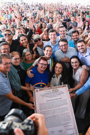 Equipe e o público exibindo o documento para foto