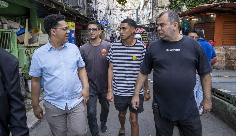 Na foto o secretário Nacional de Periferias caminha com pessoas pela Rocinha