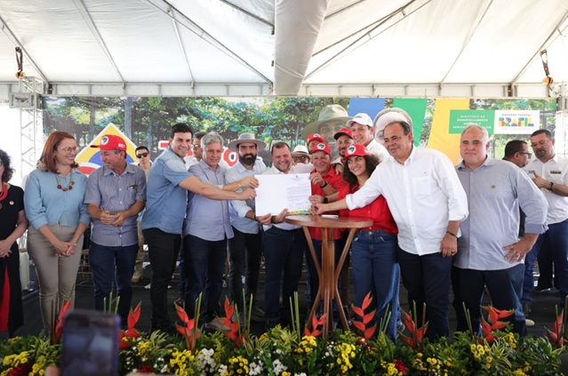 ntrega de documento reúne autoridades e produtores em assentamento rural.