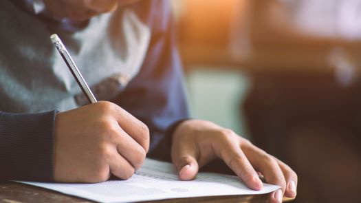 close-up-hand-writing-exam-with-students-course.jpg