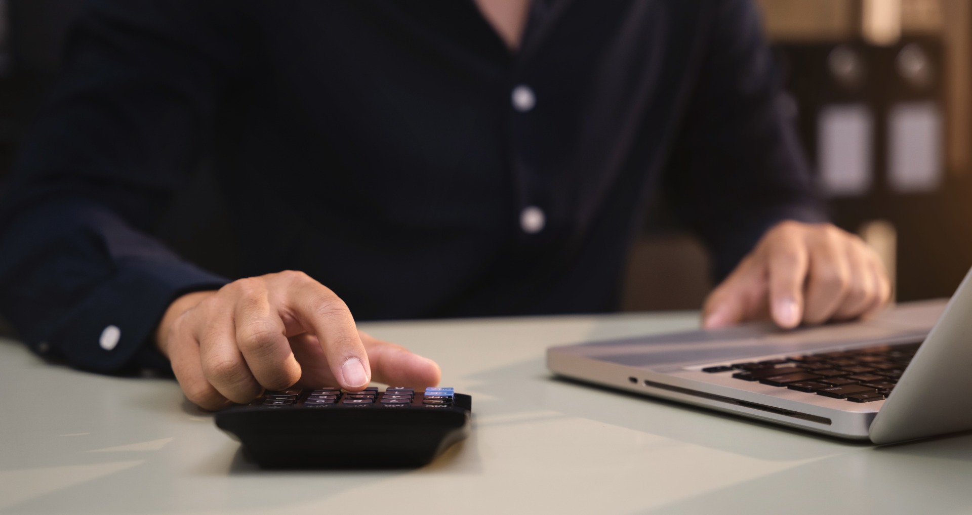 businessman-working-with-laptop-and-using-a-calcul-2022-11-01-04-02-19-utc.jpg