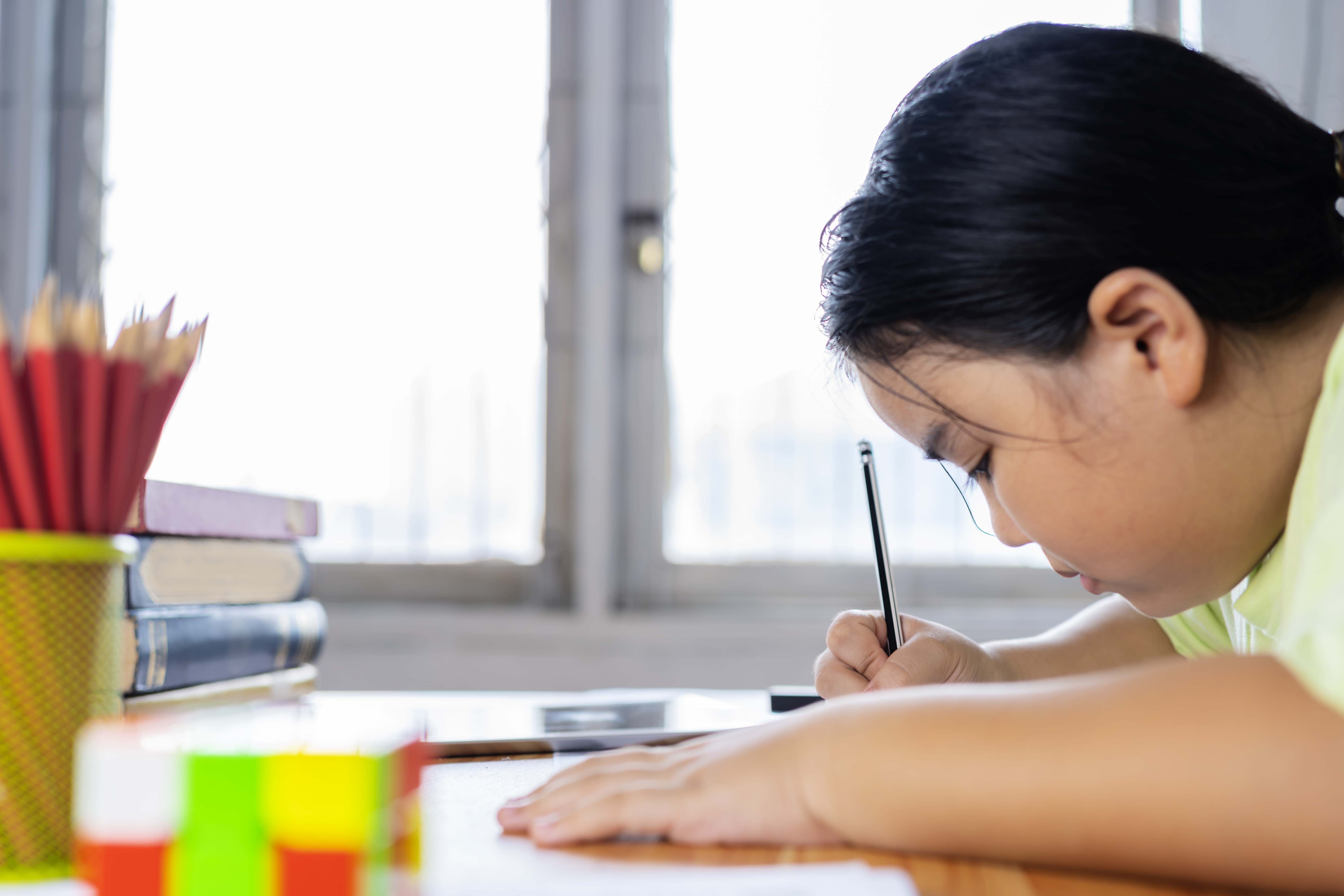 back-school-concept-asian-girl-is-doing-her-homework-practice-doing-skillenhancing-exercises.jpg