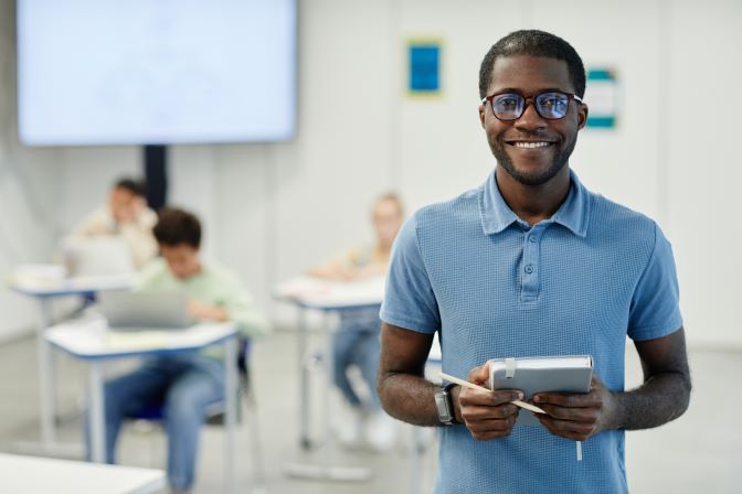 smiling-black-teacher-in-school-classroom-2023-11-27-05-10-49-utc___.jpg