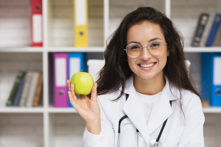 front-view-smiley-doctor-with-apple.jpg