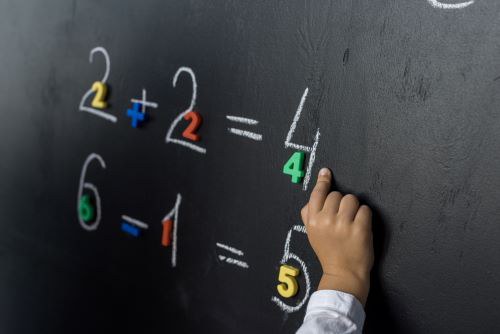 cropped-shot-of-child-studying-numbers-on-chalkboa-2022-11-02-01-13-18-utc.jpg