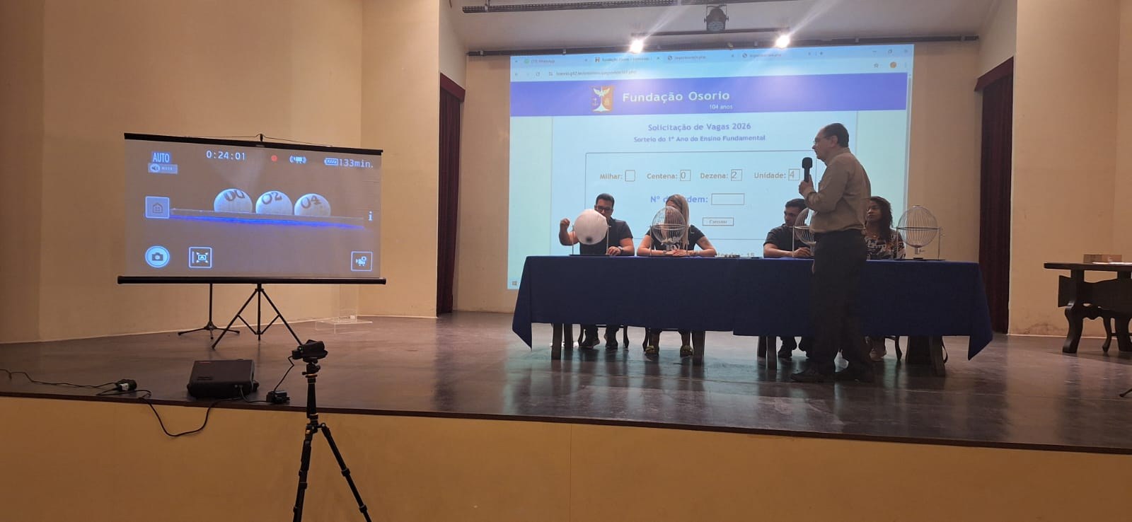 Imagem do Coordenador técnico ao microfone anunciando o início do sorteio