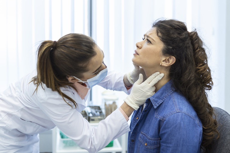 endocrinologist-examining-throat-of-young-woman-in-clinic-women-with-thyroid-gland-test-endocrinology-hormones-and-treatment-inflammation-of-the-sore-throat.jpg