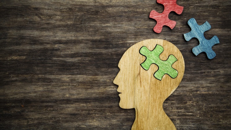 man head silhouette with jigsaw puzzle peace