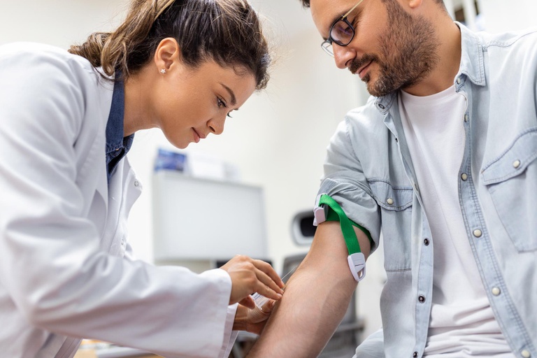friendly-hospital-phlebotomist-collecting-blood-sample-from-patient-lab-preparation-blood-test-by-female-doctor-medical-uniform-table-white-bright-room.jpg