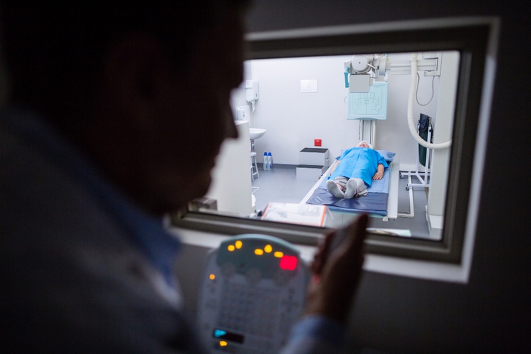 doctor-using-x-ray-unit-control-panel-patient.jpg