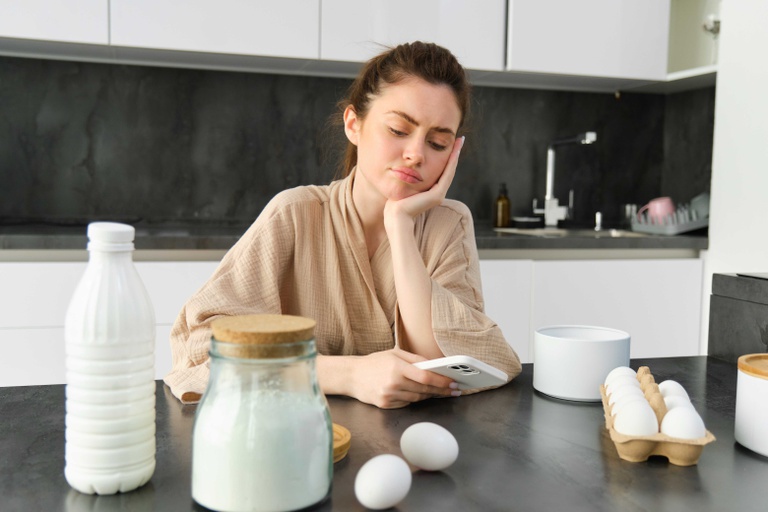 attractive-young-cheerful-girl-baking-kitchen-making-dough-holding-recipe-book-having-ideas.jpg