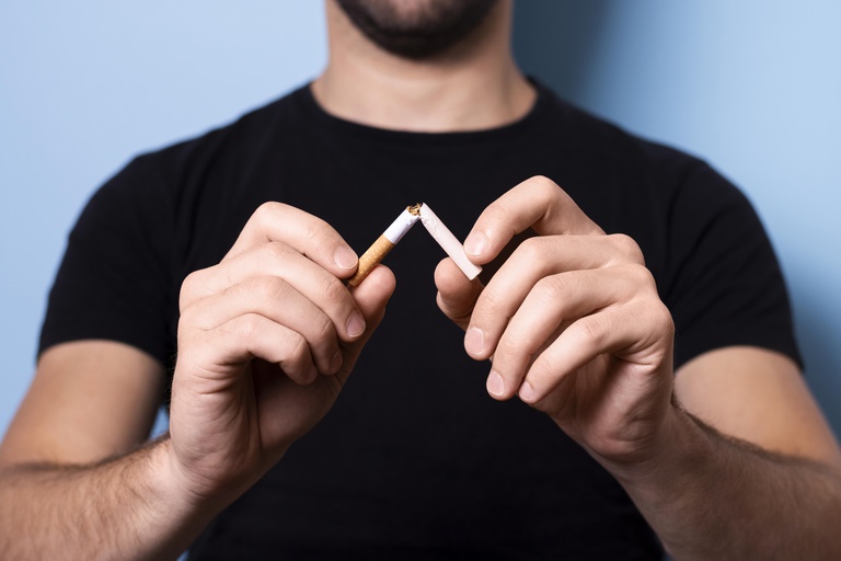 close-up-man-breaking-cigarette.jpg