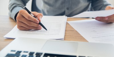 businessman-checking-documents-table.jpg