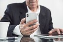 close-up-of-an-elderly-man-holding-smart-phone-in-hand.jpg