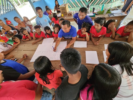 Tukano children and adults draw up a list