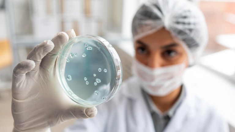 close-up-blurry-scientist-holding-petri-dish (1).jpg