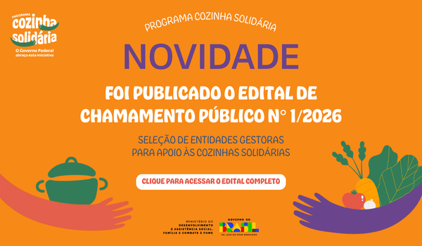 "Banner do Programa Cozinha Solidária com fundo laranja. À esquerda, o texto ‘Programa Cozinha Solidária – O Governo Federal abraça esta iniciativa’, ilustrado com braços roxos em formato de abraço. À direita, ilustrações de legumes e verduras, como tomate, cenoura, cebola e folhas verdes, também envoltos por braços roxos."