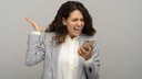 angry-business-woman-screaming-loudly-into-a-mobil-2022-08-01-04-57-37-utc.jpg