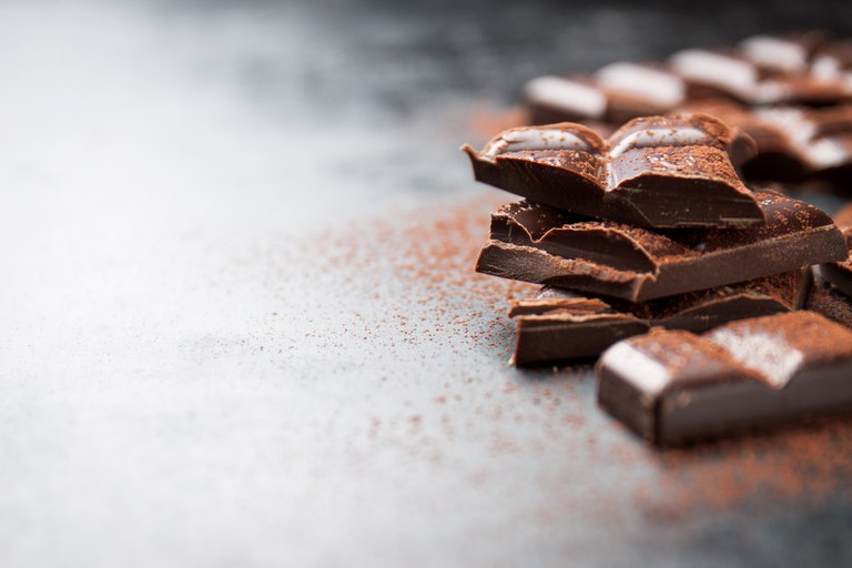 pieces-of-chocolate-on-a-wooden-table-and-cacao-sprinkled.jpg