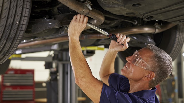 auto-mechanic-working-underneath-car-in-garage-2021-08-26-16-13-02-utc.jpg