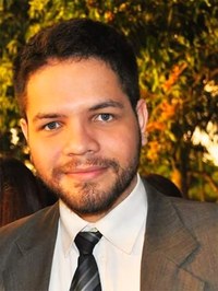 Homem com barba e cabelo curtos vestindo paletó e gravata.