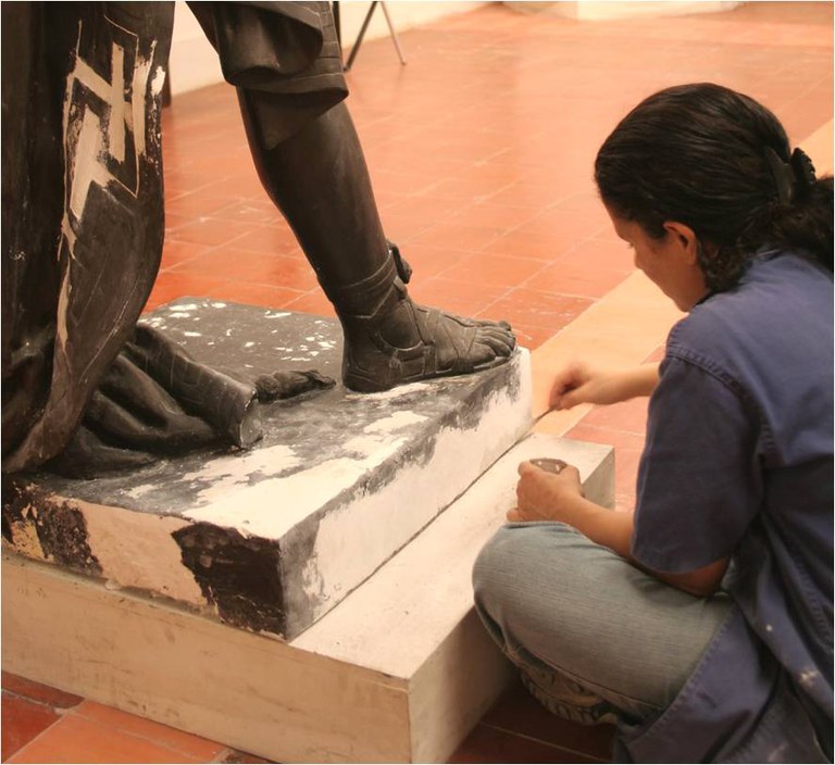 Restauradora Benvinda trabalhando na obra "A representação do ator João Caetano interpretando Oscar”, de autoria de Chaves Pinheiro
