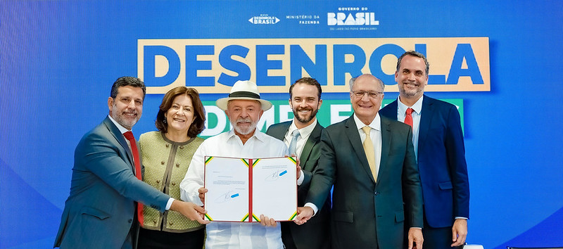 Presidente Lula, acompanhado de ministros, segura documento sobre a MP