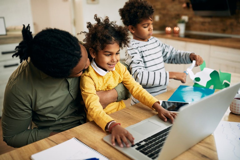 happy-african-american-little-girl-using-laptop-while-sitting-father-s-lap.jpg