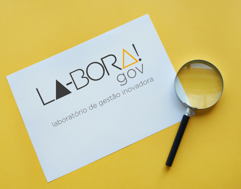 papel escrito LA-BORA!gov e uma lupa