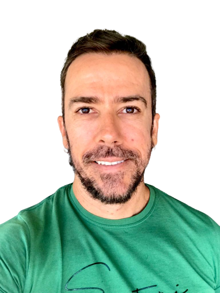com um fundo branco, um homem branco com cabelos e barba castanhas. está sorrido e veste uma camisa verde.