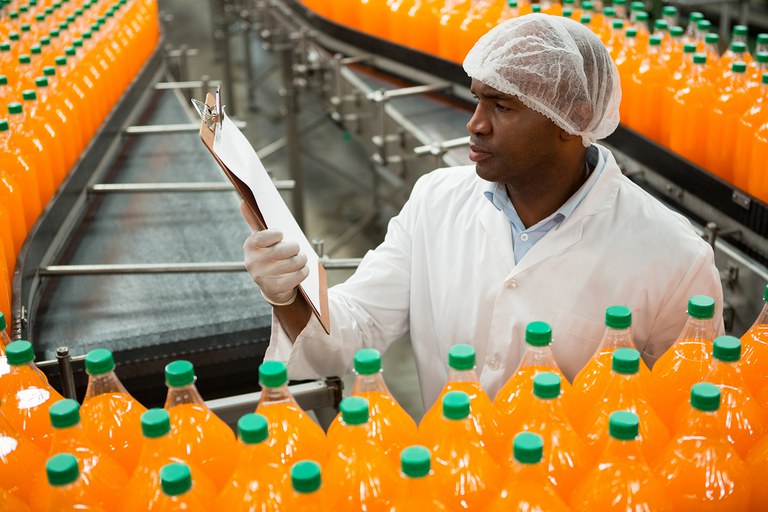 male-worker-reading-clipboard-while-inspecting-bottles-juice-factory.jpg