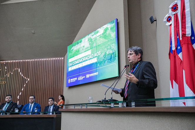 Foto mostra homem falando ao microfone