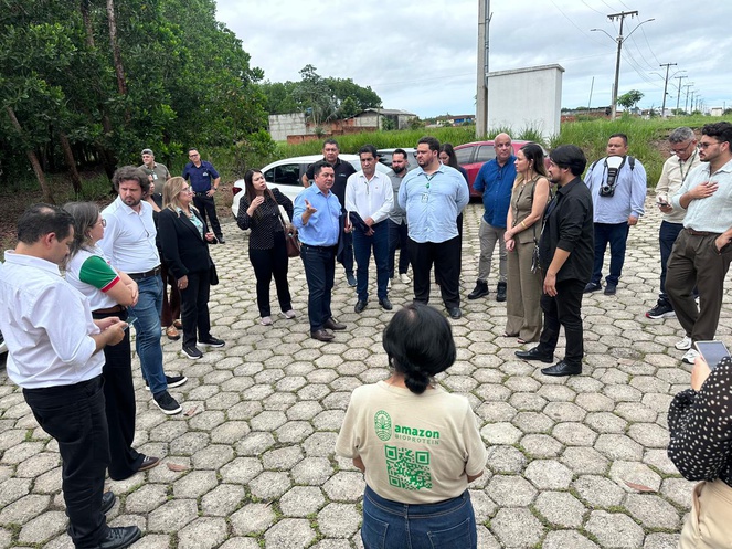 Foto mostra pessoas conversando em um estacionamento