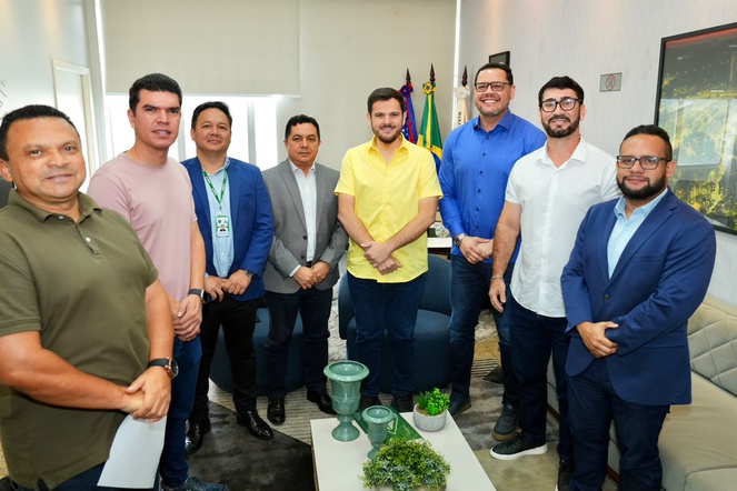 Foto mostra pessoas posando para foto, apos uma reunião