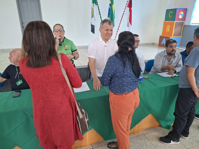 Foto mostra homem de blusa branca conversando com um mulher