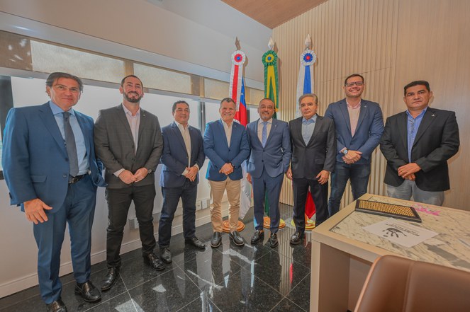 Foto mostra um grupo de pessoas posando para foto após reunião