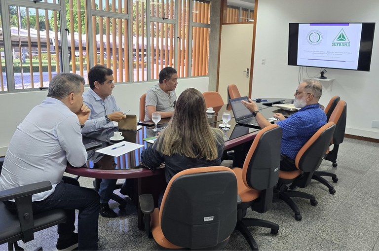 Foto mostra homem de blusa azul fazendo uma explicação a um grupo de pessoas