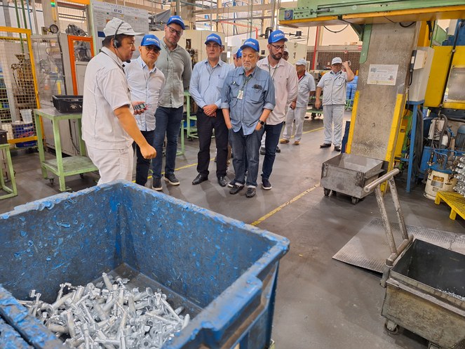 Foto mostra grupo de pessoas em visita a uma empresa