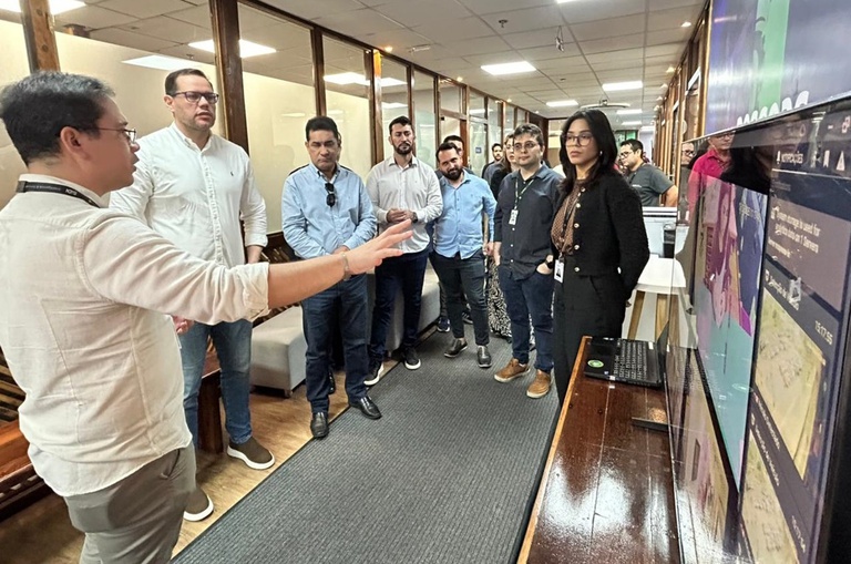 Foto mostra homem fazendo uma explanação a grupo de pessoas