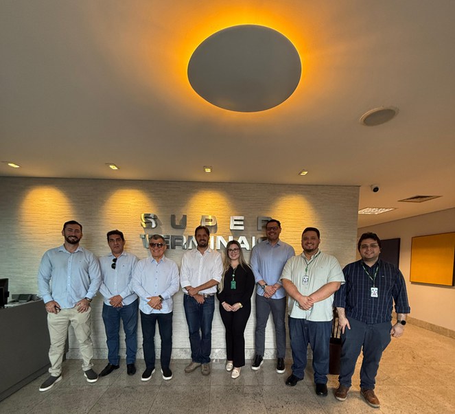 Foto mostra grupo de pessoas posando para foto com uma bela imagem luminosa sobre eles